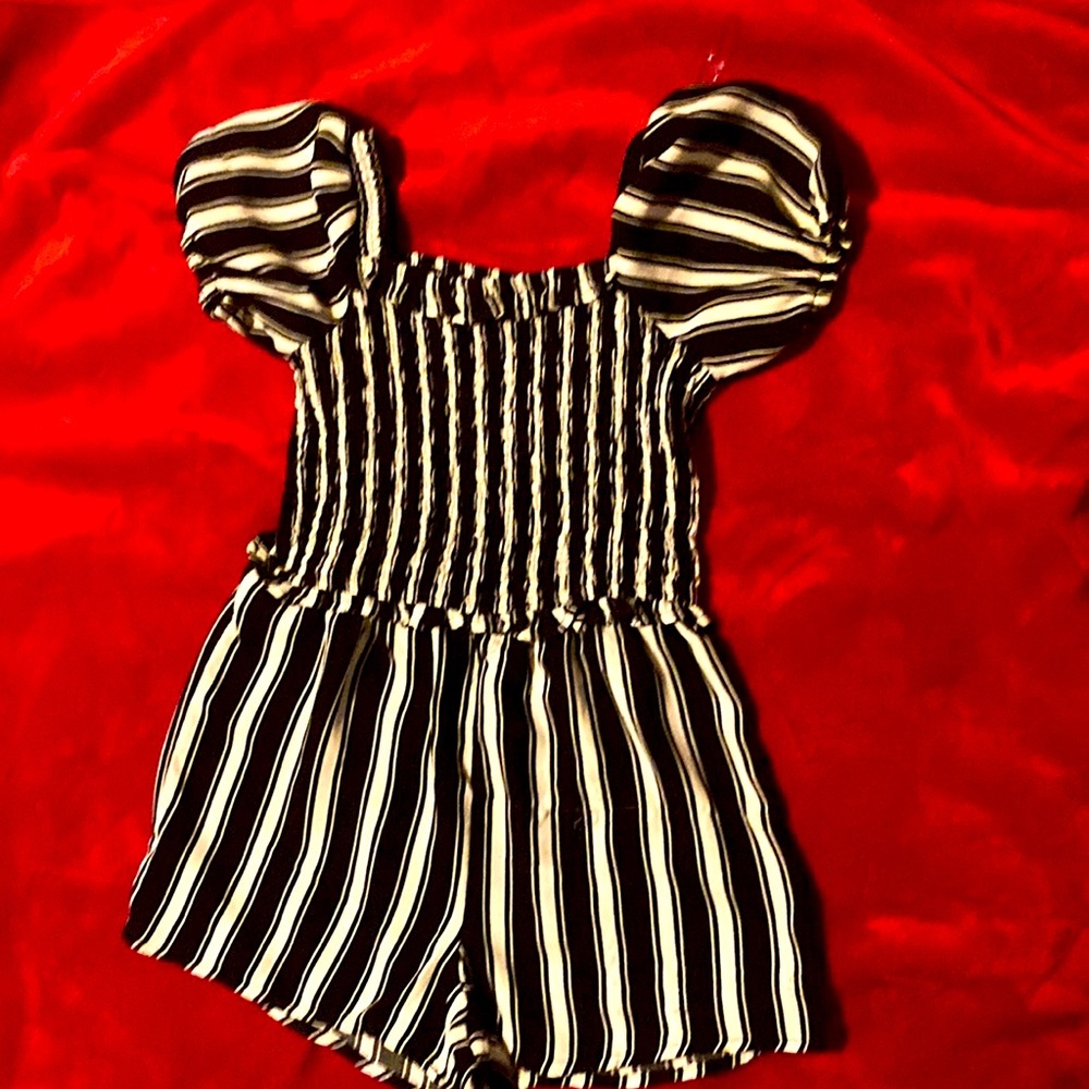 A black and white striped romper with puffy sleeves